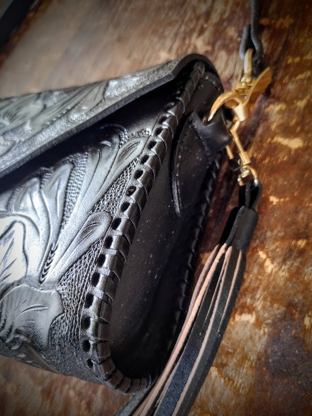 Clutch purse black with shoulder strap.