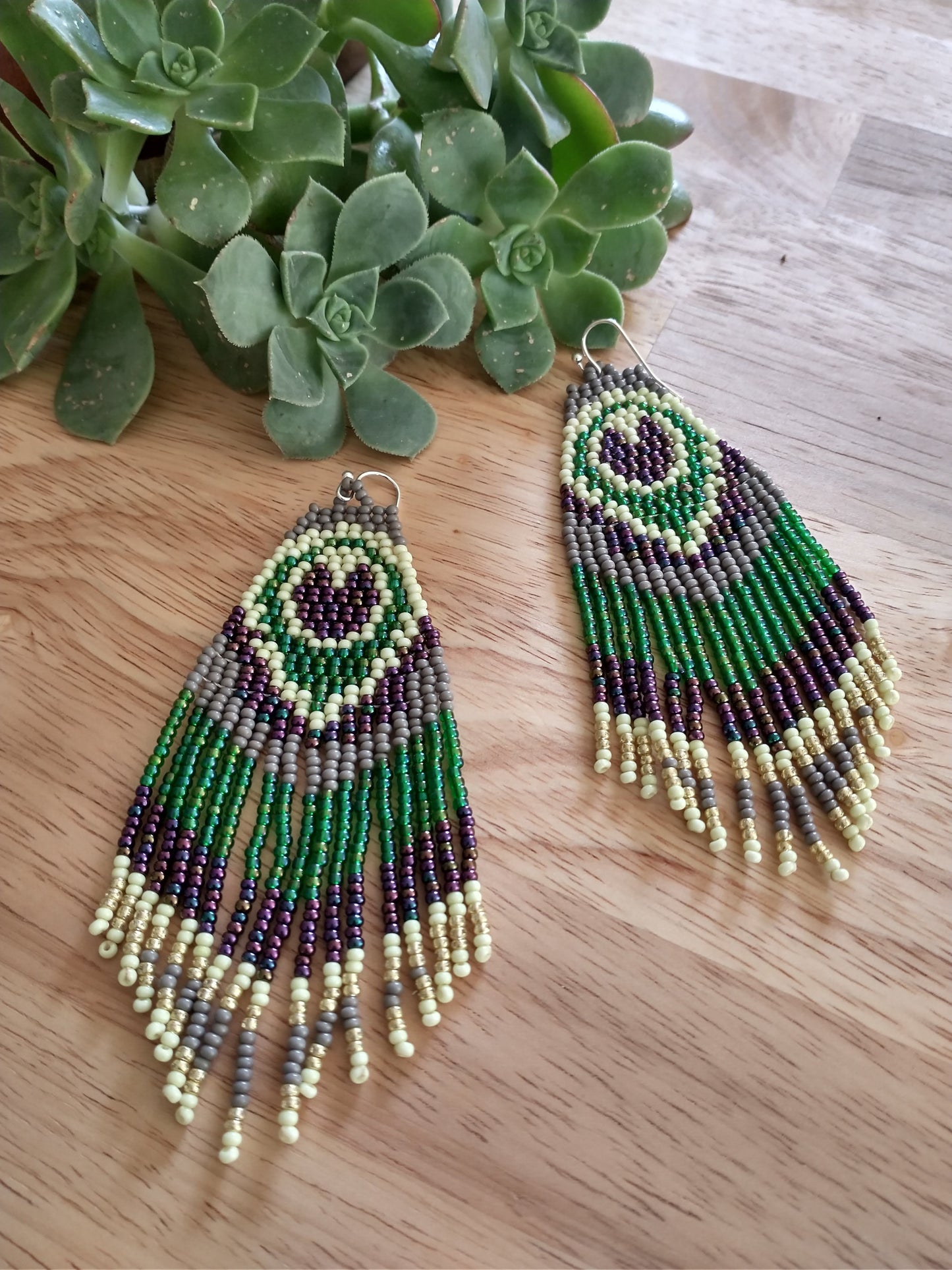 Green/grey peacock feather beaded earrings.