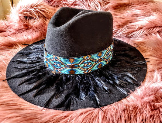 Hat embellished with feather art and beaded work.