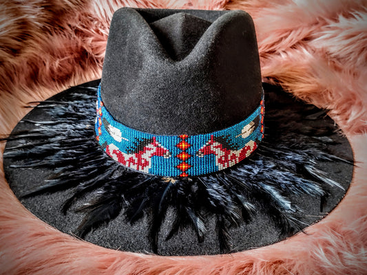 Hat embellished with feather art and beaded work.
