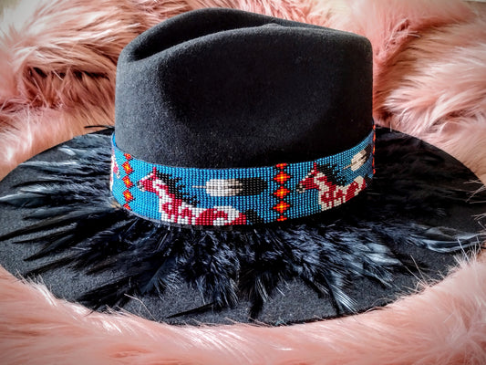 Hat embellished with feather art and beaded work.