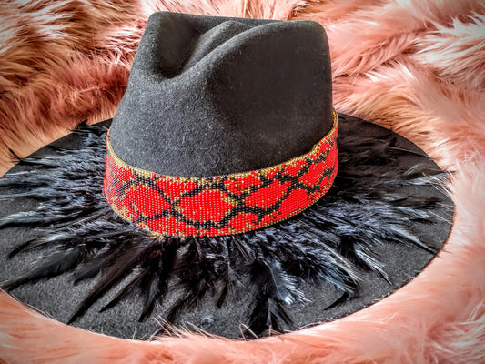 Hat embellished with feather art and beaded work.