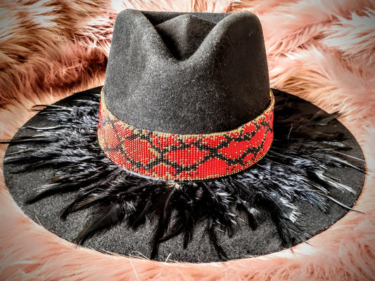 Hat embellished with feather art and beaded work.