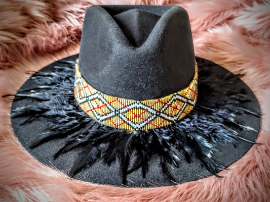 Hat embellished with feather art and beaded work.