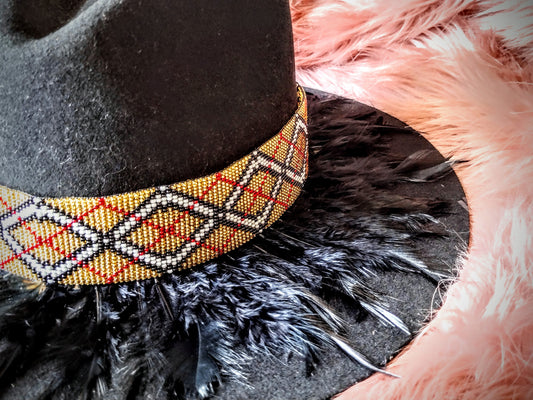 Hat embellished with feather art and beaded work.