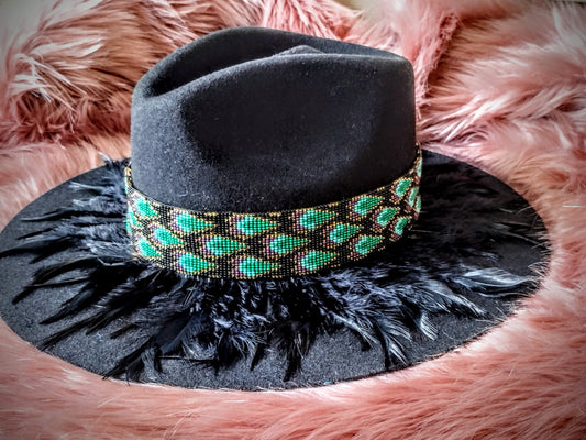 Hat embellished with feather art and beaded work.