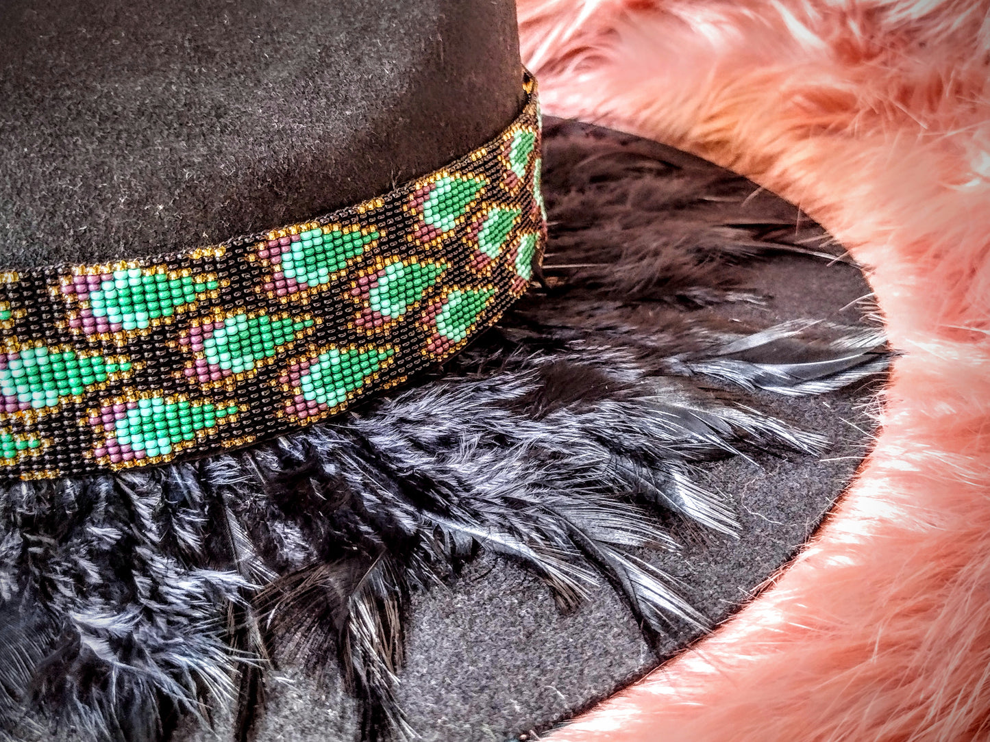 Hat embellished with feather art and beaded work.