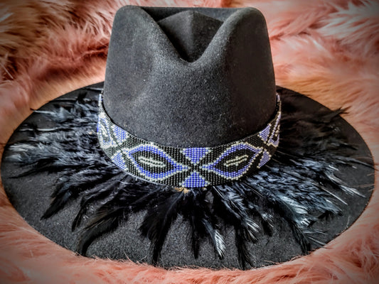 Hat embellished with feather art and beaded work.