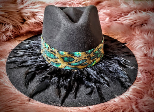 Hat embellished with feather art and beaded work.