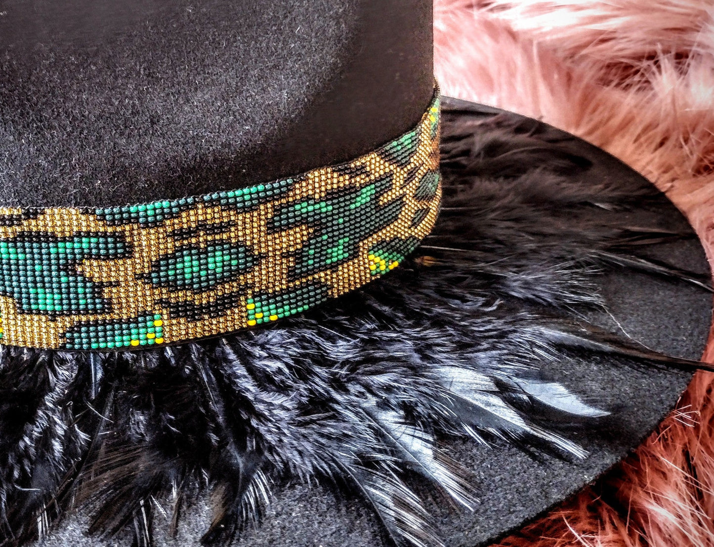 Hat embellished with feather art and beaded work.