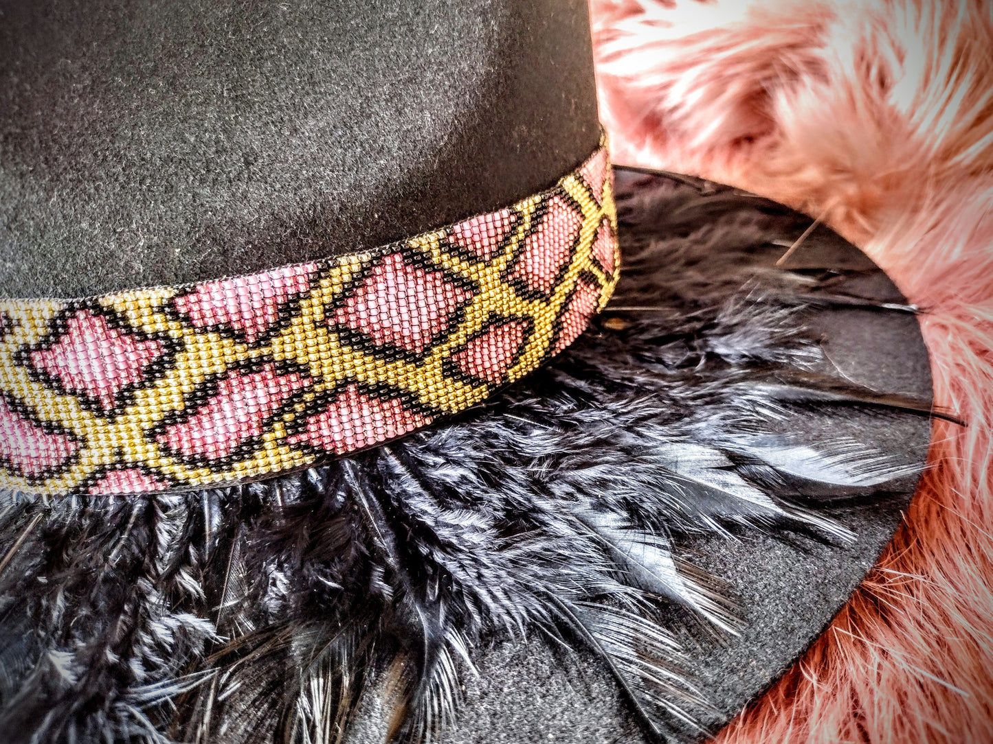 Hat embellished with feather art and beaded work.