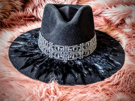 Hat embellished with feather art and beaded work.