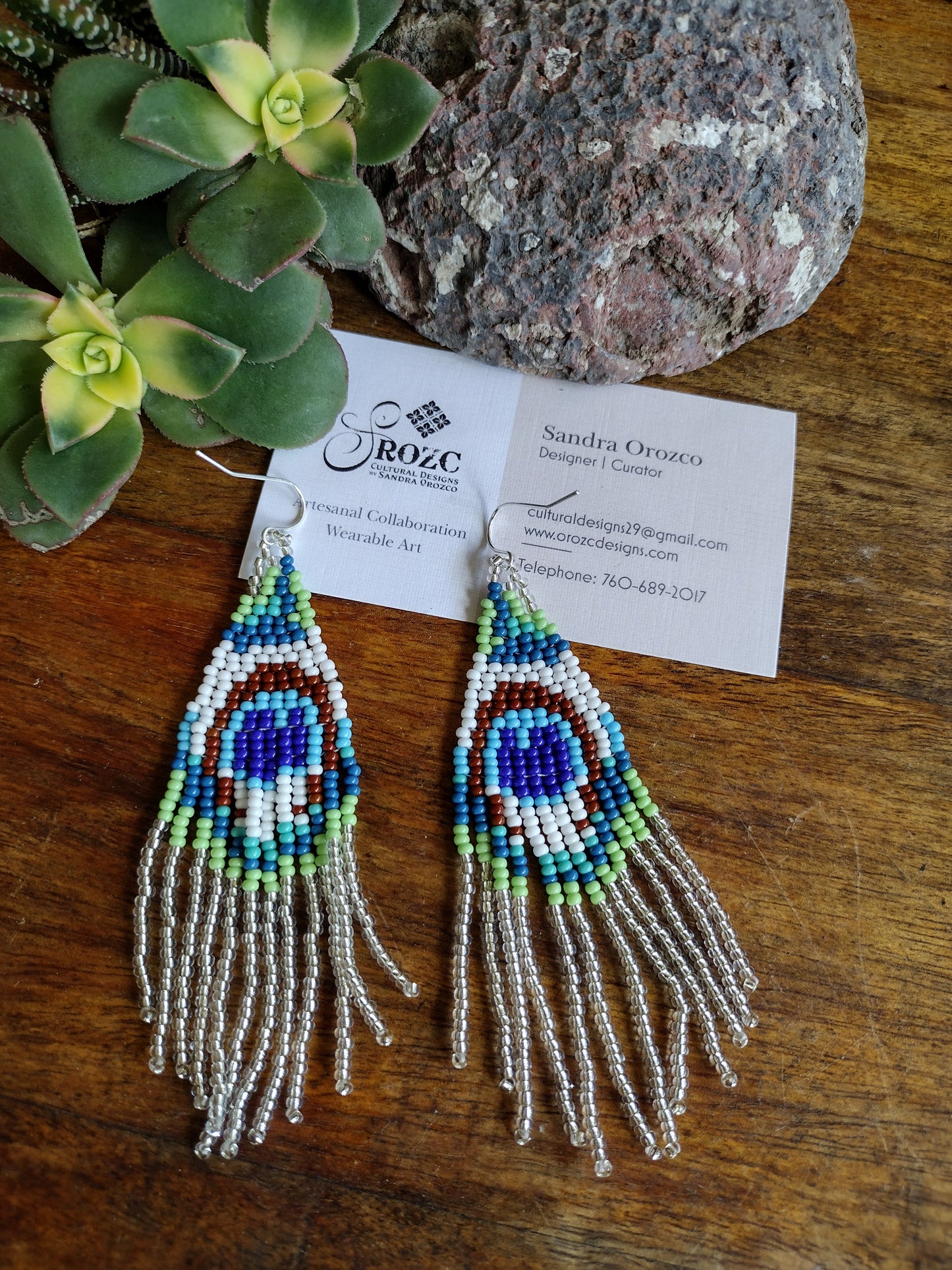 Silver/white peacock feather beaded earrings.